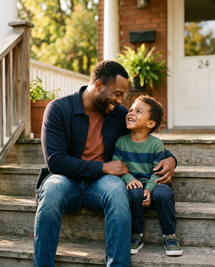 A father sharing a warm, meaningful moment with his young son on their front steps.